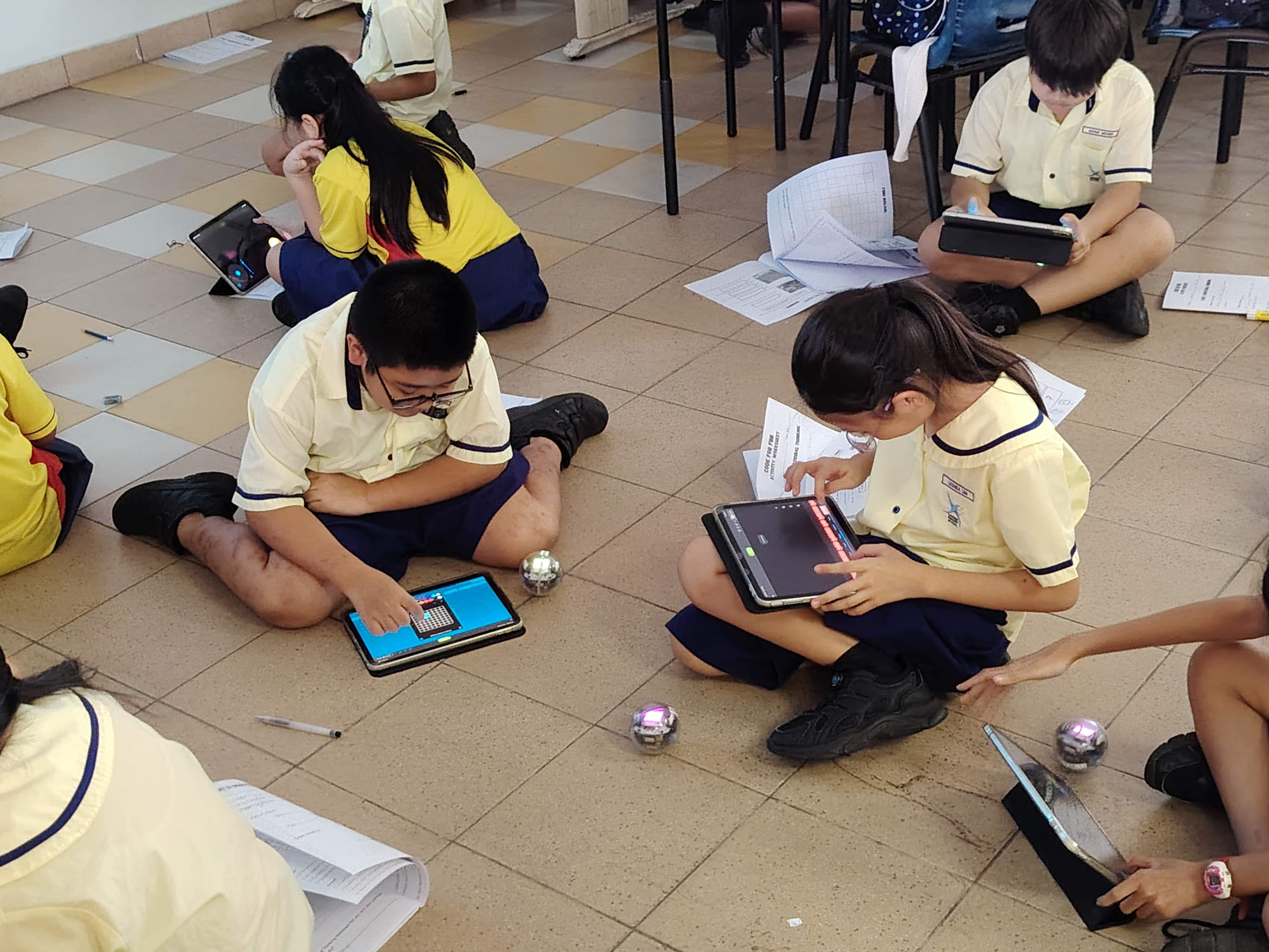 Lakeside Primary School pupils program small robots using tablets